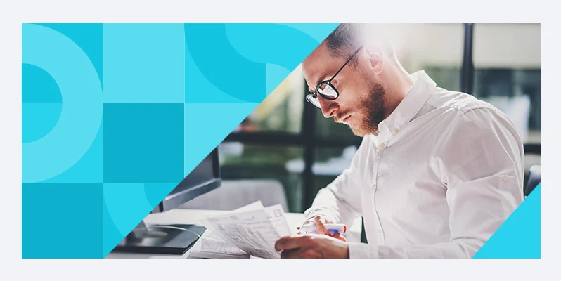 Man looking at paperwork at his desk